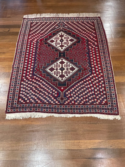 Decorative rug with intricate patterns on a wooden floor